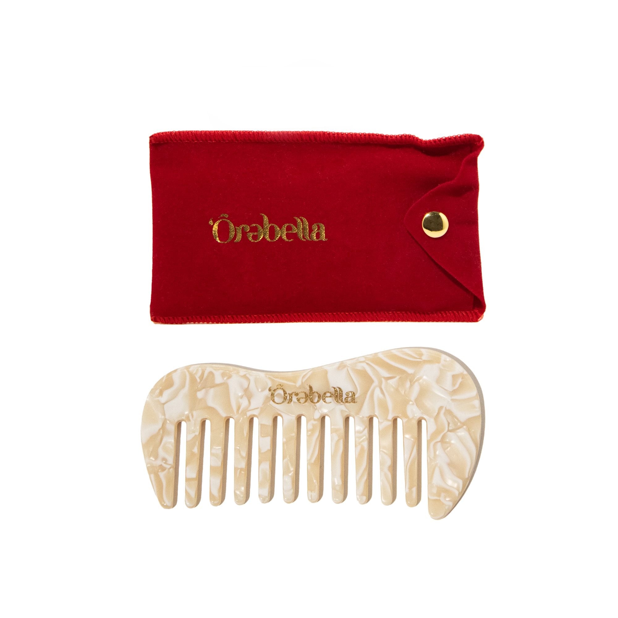 Red velvet pouch with gold snap closure and matching cream-colored shell-shaped comb with decorative pattern