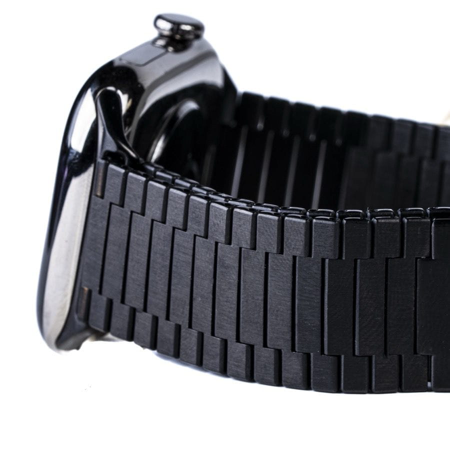 Close-up detail of black metal bracelet links and watch case side profile