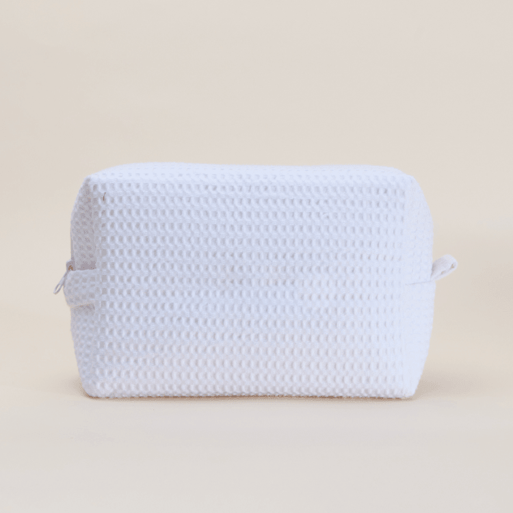White waffle-textured cosmetic pouch with small handles
