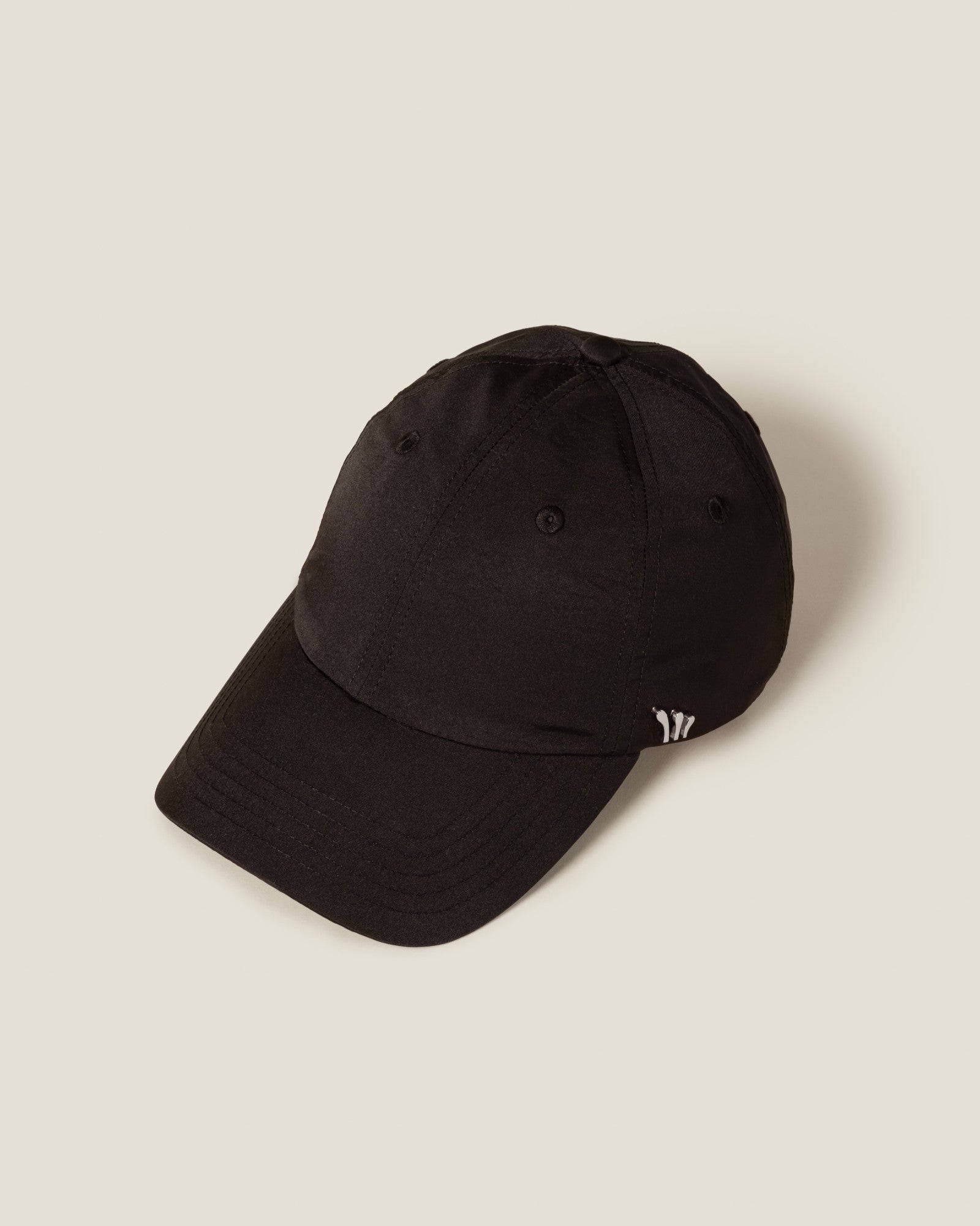 Black baseball cap with embroidered logo detail on the side