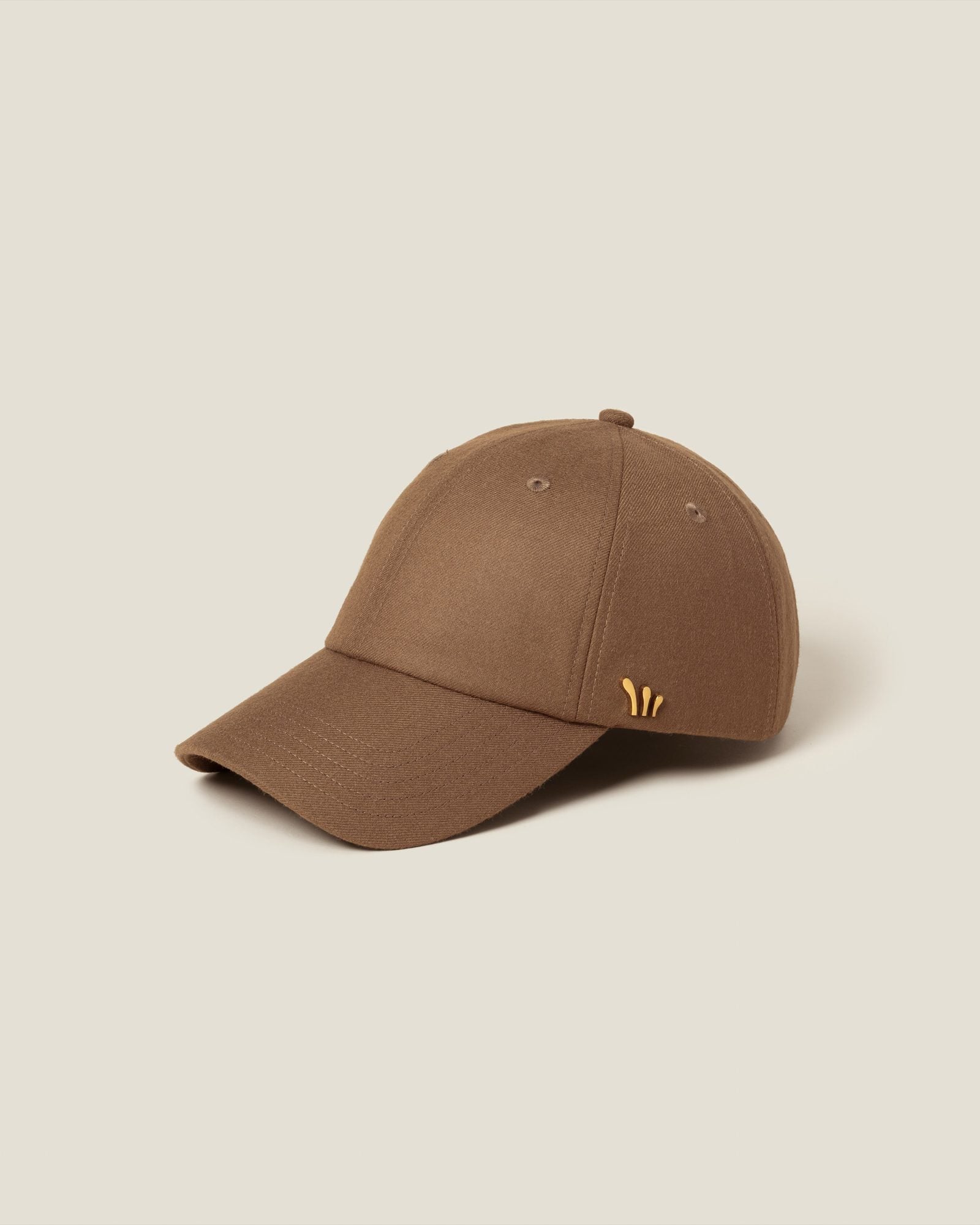 Tan baseball cap with small embroidered logo on the side