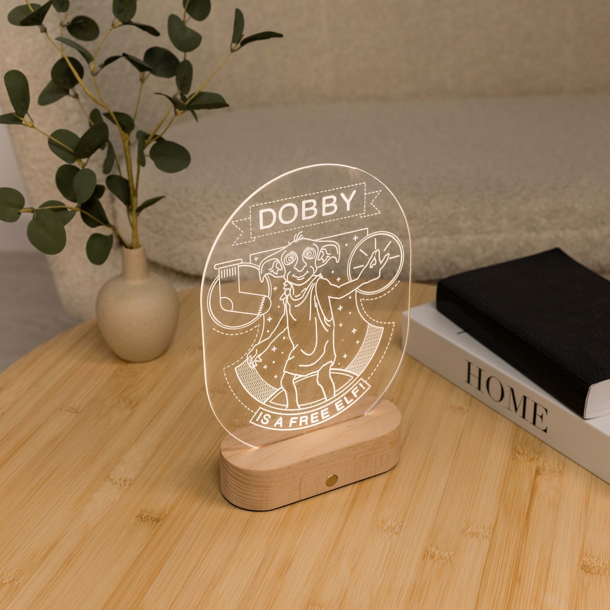 Dobby character acrylic light display on wooden base positioned on wooden desk with home decor