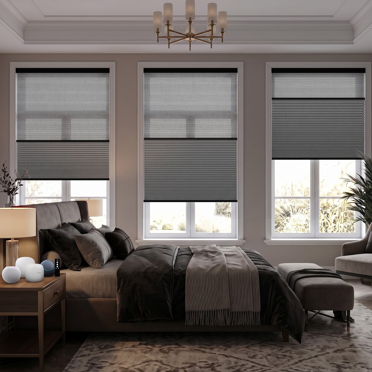 Modern bedroom with three large windows featuring motorized cellular shades in gray and white tones with a bed, nightstand, and chandelier