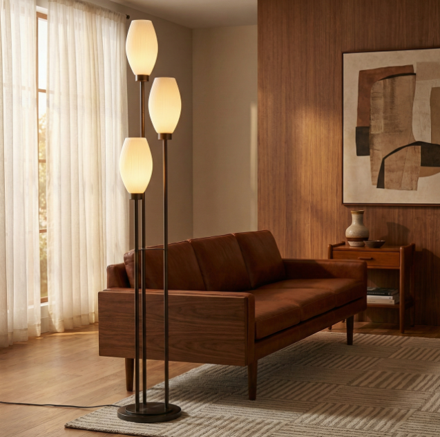 Floor lamps are architectural elements that define living spaces through light and form. Beyond their practical role as ambient light sources, lamps shape how we experience rooms, determining whether spaces feel cozy or open, intimate or energizing. A strategically placed lamp can anchor a seating area, highlight architectural details and establish the visual personality of an entire room. The right lamp transforms ordinary living spaces into carefully curated environments that invite relaxation and social connection.